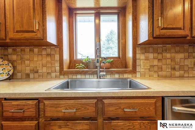 926 Iron Rd, Papillion, NE 68046 - kitchen with a sink, light countertops, brown cabinets, and tasteful backsplash