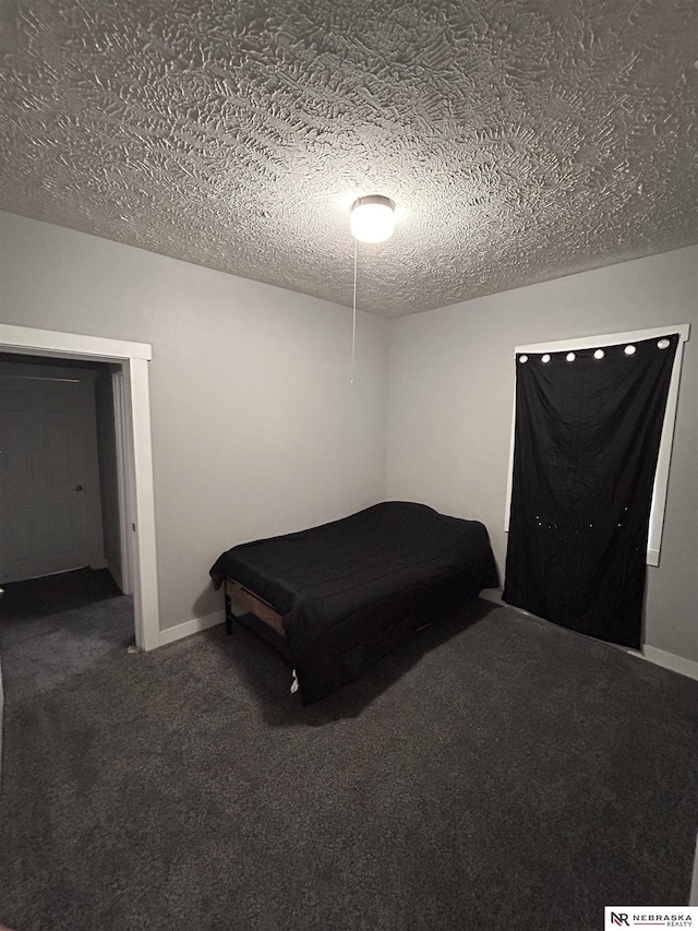 2413 Ohio St, Omaha, NE 68111 - carpeted bedroom featuring a textured ceiling and baseboards