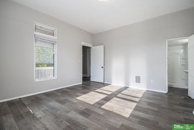 1320 N 40th St, Omaha, NE 68131 - unfurnished bedroom featuring wood finished floors, baseboards, and ensuite bathroom
