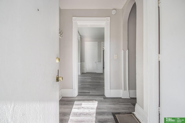1320 N 40th St, Omaha, NE 68131 - hallway featuring arched walkways, wood finished floors, and baseboards