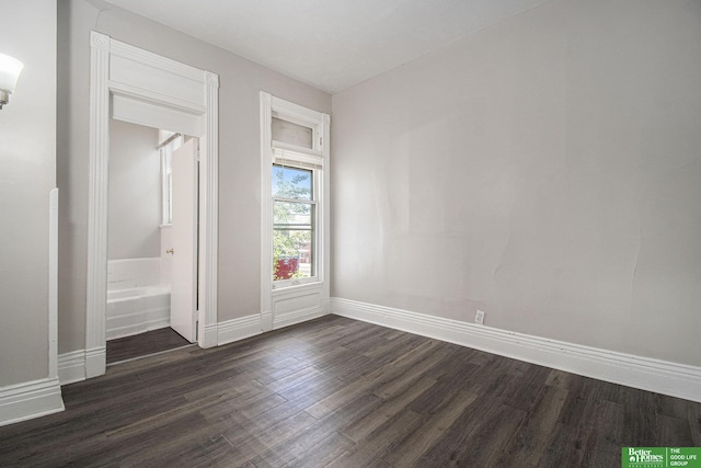 1320 N 40th St, Omaha, NE 68131 - unfurnished bedroom featuring dark wood finished floors and baseboards