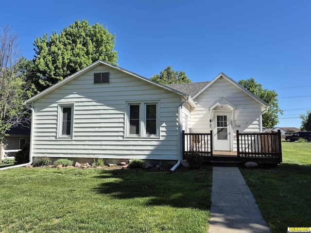 1112 10th St, Auburn, NE 68305 - view of front of property with a front lawn, a wooden deck, and roof with shingles