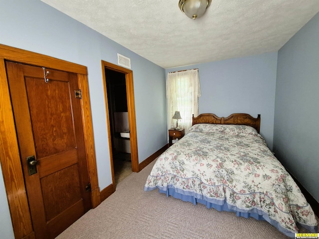 1112 10th St, Auburn, NE 68305 - carpeted bedroom with baseboards and a textured ceiling