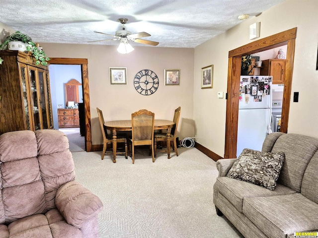 1112 10th St, Auburn, NE 68305 - carpeted dining room featuring ceiling fan, baseboards, and a textured ceiling