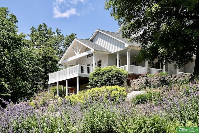 8112 Molokai Dr, Papillion, NE 68046 - view of side of home with a shingled roof and a porch