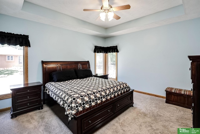 8112 Molokai Dr, Papillion, NE 68046 - bedroom featuring light carpet, baseboards, a tray ceiling, and a ceiling fan