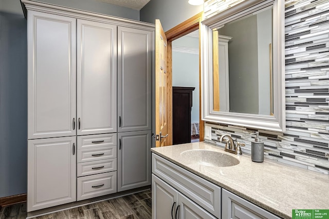 8112 Molokai Dr, Papillion, NE 68046 - bathroom with vanity, tasteful backsplash, and wood finished floors