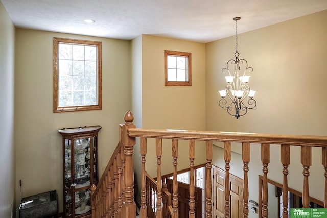 8112 Molokai Dr, Papillion, NE 68046 - hall with healthy amount of natural light, a chandelier, an upstairs landing, and recessed lighting