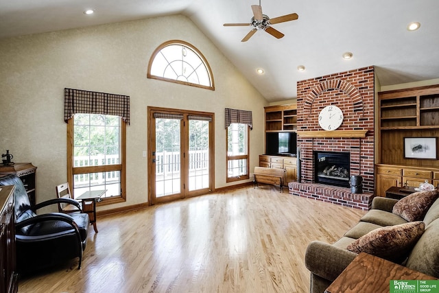 8112 Molokai Dr, Papillion, NE 68046 - living room with a ceiling fan, wood finished floors, a fireplace, built in features, and high vaulted ceiling