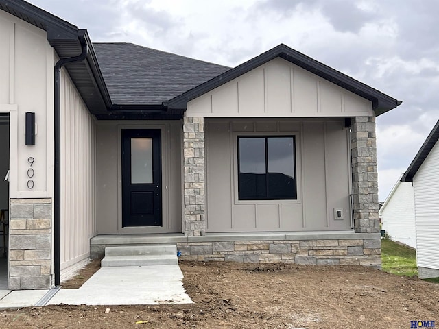 900 Middleton Ave, Lincoln, NE 68521 - doorway to property featuring a shingled roof, board and batten siding, and stone siding
