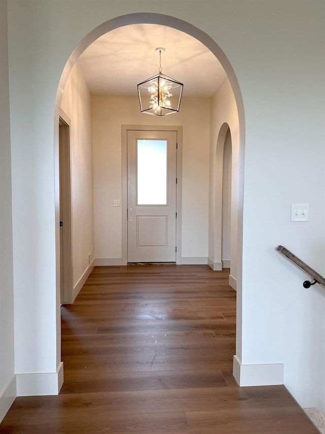 900 Middleton Ave, Lincoln, NE 68521 - entrance foyer featuring wood finished floors, a chandelier, baseboards, and arched walkways