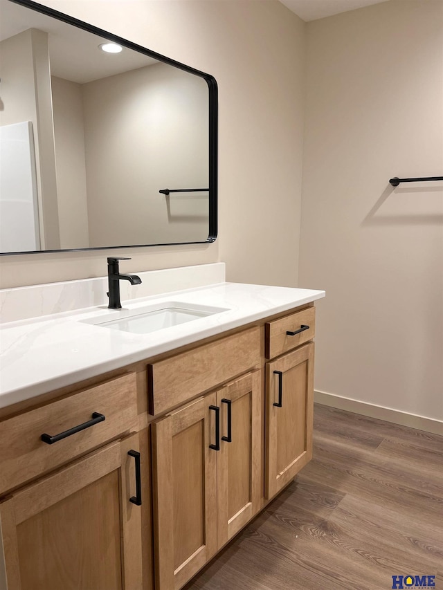 900 Middleton Ave, Lincoln, NE 68521 - bathroom with vanity, wood finished floors, baseboards, and recessed lighting