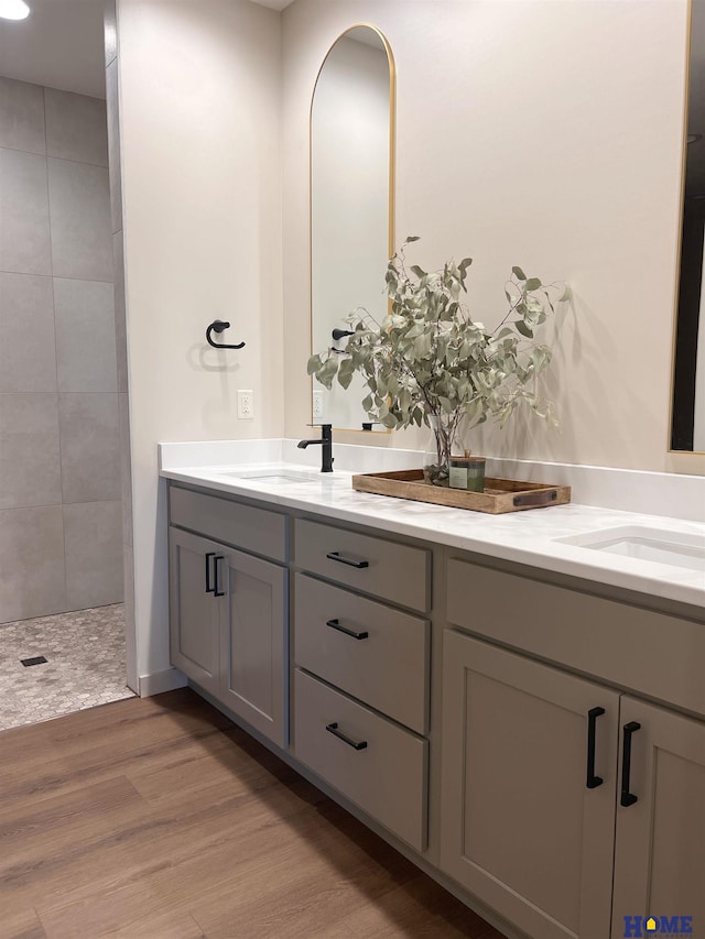 900 Middleton Ave, Lincoln, NE 68521 - full bath featuring double vanity, wood finished floors, and tiled shower