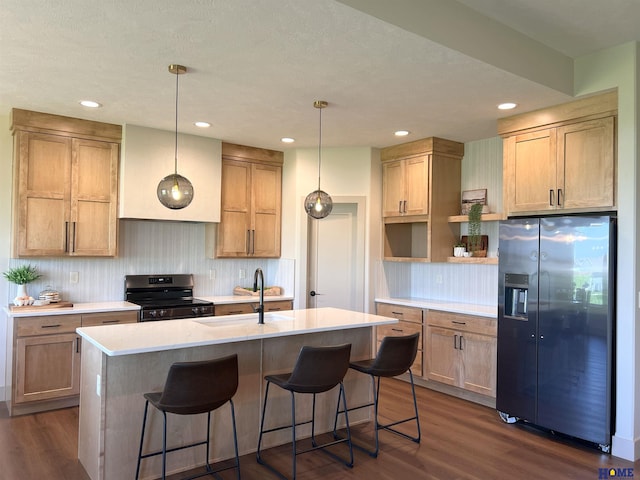 900 Middleton Ave, Lincoln, NE 68521 - kitchen with stainless steel appliances, a sink, dark wood-style floors, an island with sink, and recessed lighting
