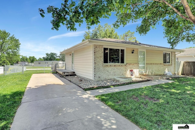 1206 W Ryons St, Lincoln, NE 68522 - view of front facade featuring brick siding, concrete driveway, and a deck