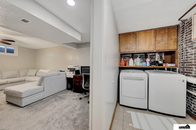 1206 W Ryons St, Lincoln, NE 68522 - laundry room featuring cabinet space, independent washer and dryer, a desk, ceiling fan, and light tile patterned floors