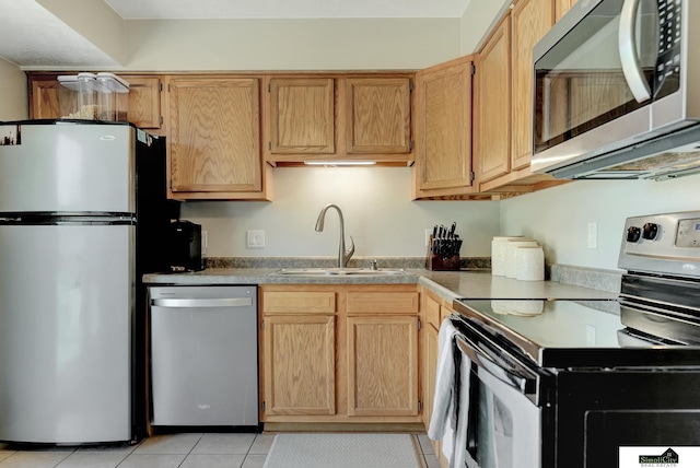 1206 W Ryons St, Lincoln, NE 68522 - kitchen with stainless steel appliances, a sink, and light tile patterned floors