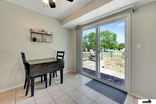 1206 W Ryons St, Lincoln, NE 68522 - dining space with ceiling fan, baseboards, and light tile patterned flooring