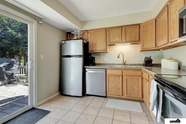 1206 W Ryons St, Lincoln, NE 68522 - kitchen with stainless steel appliances, a sink, and light tile patterned flooring
