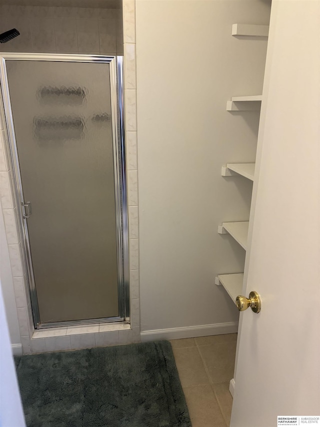 1231 S 121st Plz Unit 312, Omaha, NE 68144 - full bathroom featuring tile patterned flooring, a stall shower, and baseboards