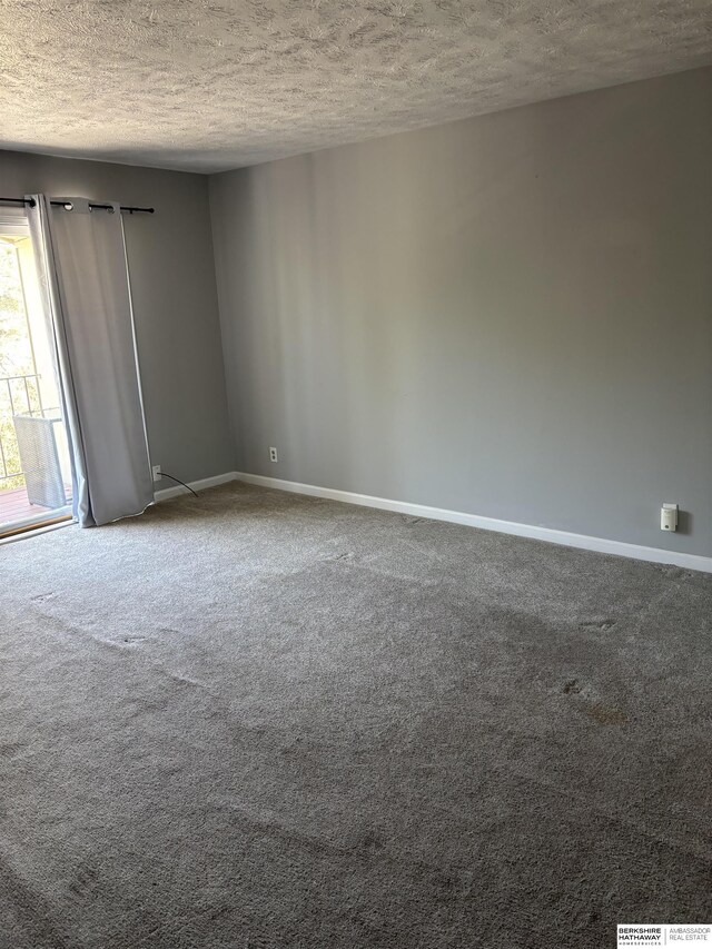 1231 S 121st Plz Unit 312, Omaha, NE 68144 - carpeted empty room featuring a textured ceiling and baseboards