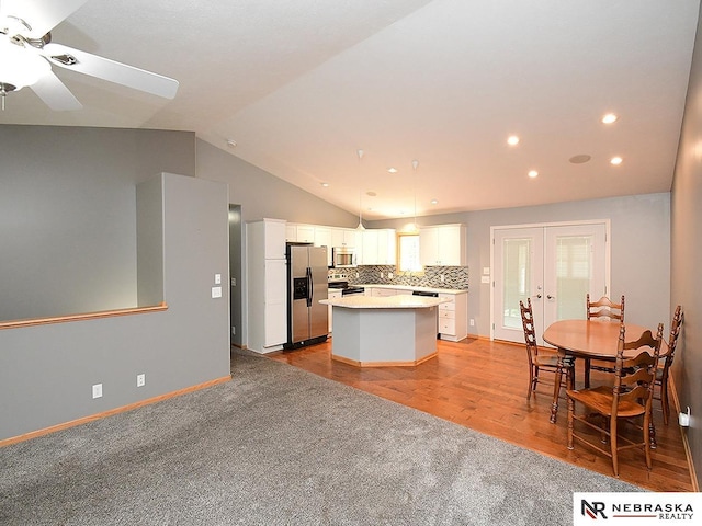 1853 SW 38th St, Lincoln, NE 68522 - kitchen featuring appliances with stainless steel finishes, french doors, a center island, lofted ceiling, and ceiling fan