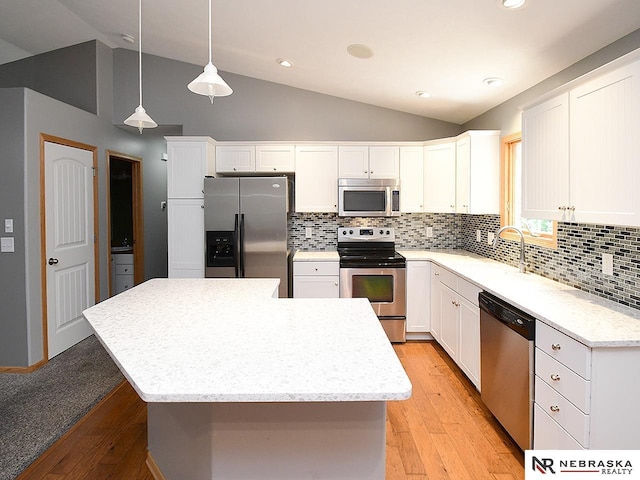 1853 SW 38th St, Lincoln, NE 68522 - kitchen with appliances with stainless steel finishes, lofted ceiling, light wood-type flooring, white cabinets, and recessed lighting