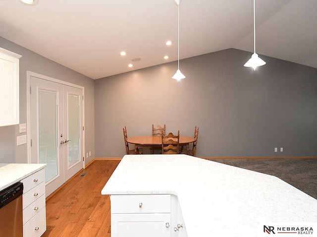 1853 SW 38th St, Lincoln, NE 68522 - kitchen featuring dishwasher, white cabinetry, light countertops, hanging light fixtures, and lofted ceiling