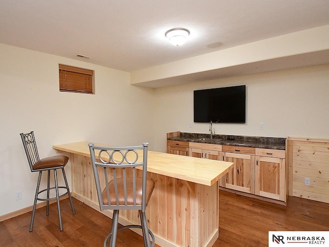 1853 SW 38th St, Lincoln, NE 68522 - indoor wet bar featuring dark wood-style flooring and baseboards