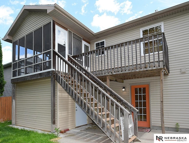 1853 SW 38th St, Lincoln, NE 68522 - rear view of property featuring a sunroom, a deck, and a patio