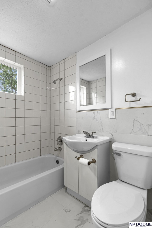 5435 S 18th St, Omaha, NE 68107 - full bathroom with tile walls, vanity, tub / shower combination, marble finish flooring, and toilet