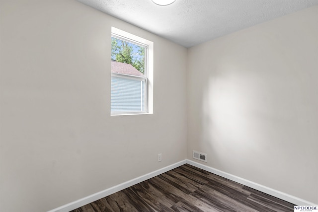 5435 S 18th St, Omaha, NE 68107 - spare room with baseboards, dark wood-style flooring, and a textured ceiling