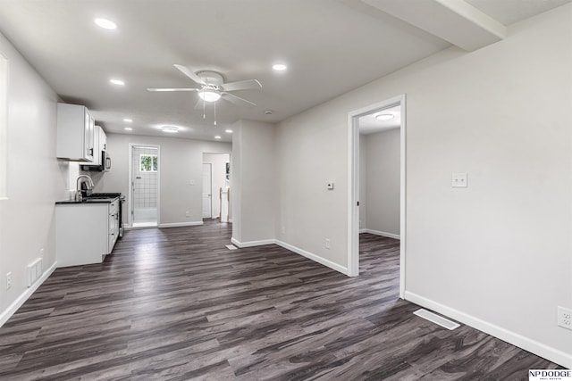 5435 S 18th St, Omaha, NE 68107 - kitchen with recessed lighting, a ceiling fan, dark wood-type flooring, dark countertops, and baseboards
