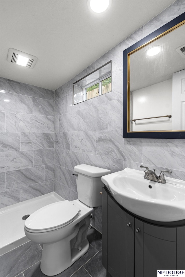 5435 S 18th St, Omaha, NE 68107 - full bath featuring tile walls, vanity, a shower stall, and toilet