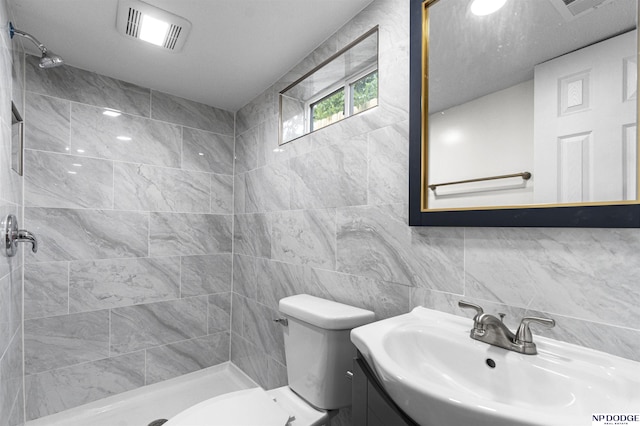 5435 S 18th St, Omaha, NE 68107 - full bath with tiled shower, vanity, toilet, tile walls, and decorative backsplash