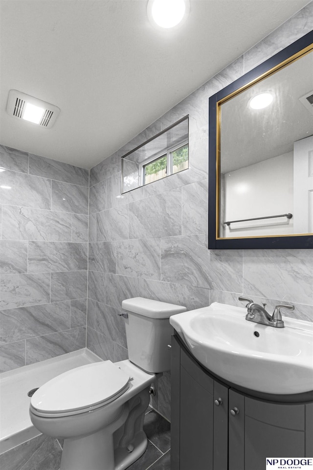 5435 S 18th St, Omaha, NE 68107 - full bathroom featuring vanity, tile walls, toilet, a stall shower, and decorative backsplash