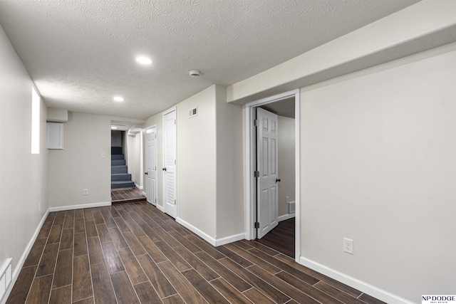 5435 S 18th St, Omaha, NE 68107 - unfurnished room with baseboards, dark wood-style flooring, a textured ceiling, recessed lighting, and stairway