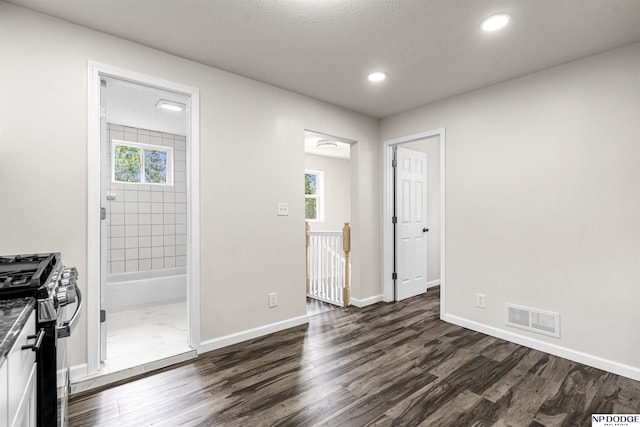 5435 S 18th St, Omaha, NE 68107 - kitchen featuring stainless steel gas range oven, dark wood finished floors, plenty of natural light, and recessed lighting