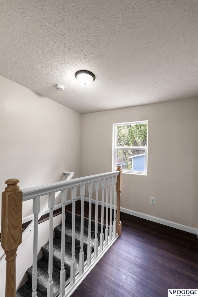 5437 S 18th St, Omaha, NE 68107 - staircase with wood finished floors, baseboards, and a textured ceiling