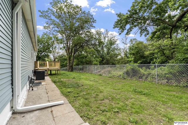 5437 S 18th St, Omaha, NE 68107 - view of yard with a wooden deck, view of scattered trees, and central air condition unit