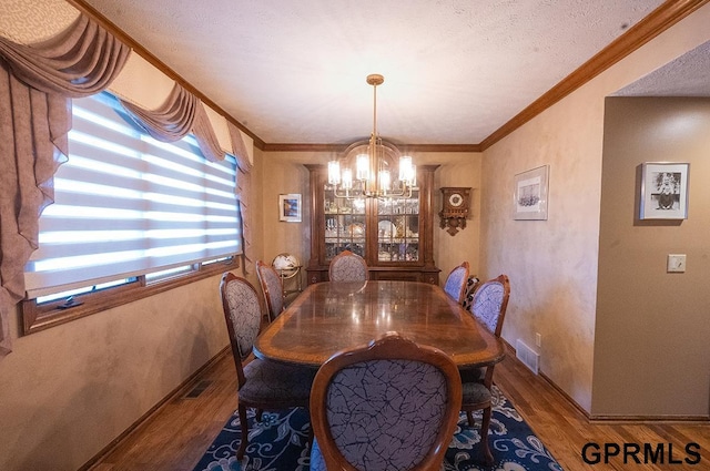 10755 Berry Plz, Omaha, NE 68127 - dining space with a chandelier, wood finished floors, baseboards, and ornamental molding
