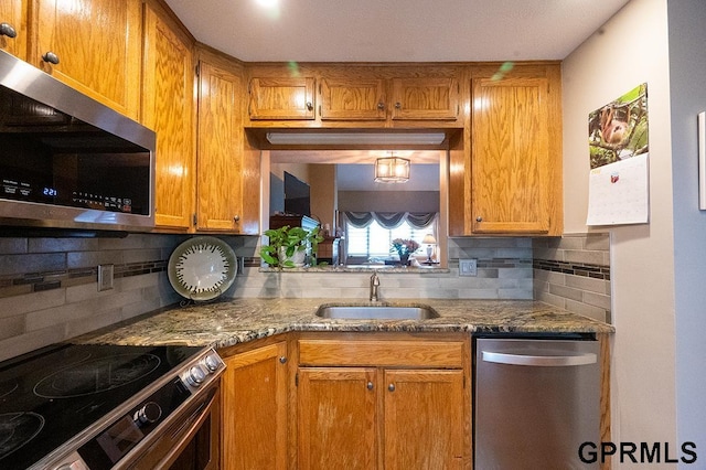 10755 Berry Plz, Omaha, NE 68127 - kitchen with stainless steel appliances, a sink, decorative backsplash, and brown cabinetry