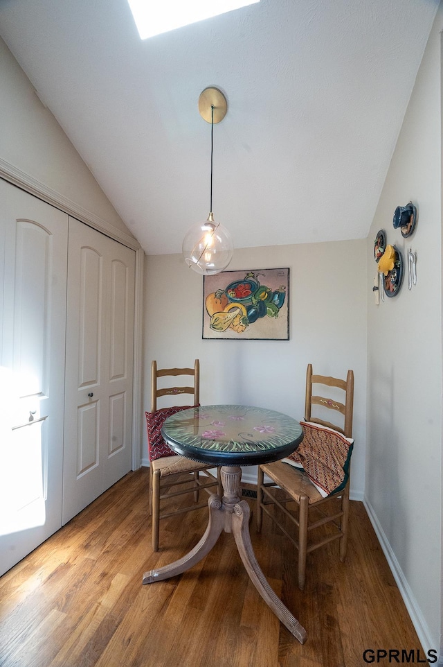 10755 Berry Plz, Omaha, NE 68127 - dining area with vaulted ceiling and light wood-type flooring