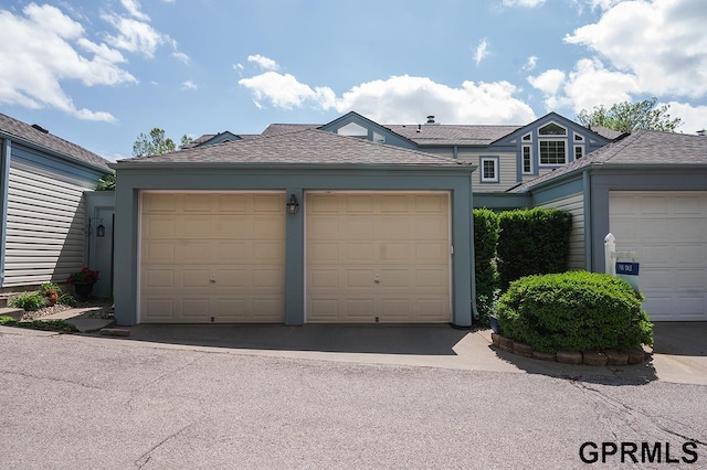 10755 Berry Plz, Omaha, NE 68127 - view of front of home with roof with shingles and community garages