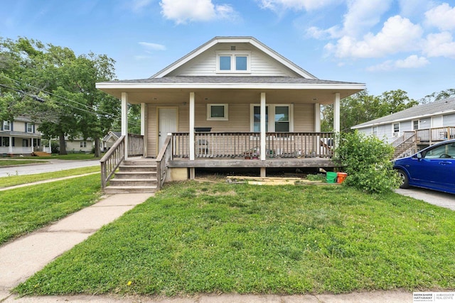 1152 N D St, Fremont, NE 68025 - view of front of house featuring a porch, a front lawn, and roof with shingles