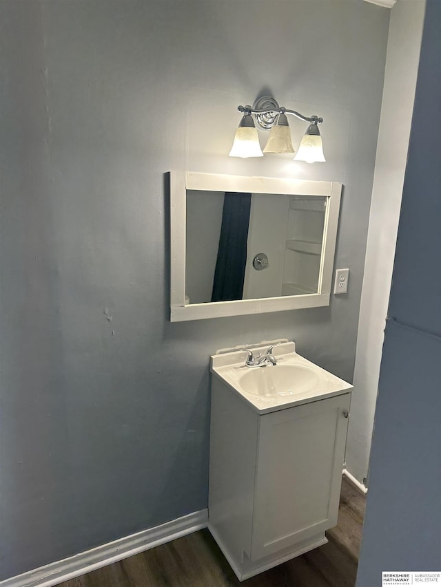 1152 N D St, Fremont, NE 68025 - bathroom with wood finished floors, baseboards, and vanity