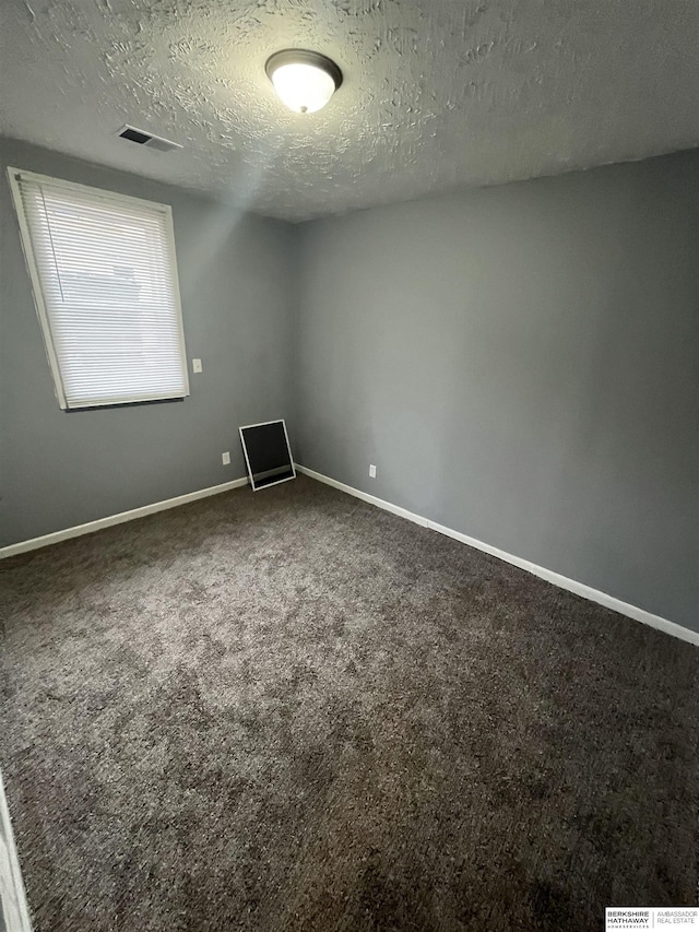 1152 N D St, Fremont, NE 68025 - carpeted spare room featuring a textured ceiling and baseboards