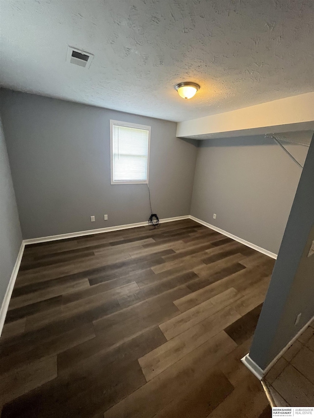 1152 N D St, Fremont, NE 68025 - unfurnished bedroom featuring wood finished floors, baseboards, and a textured ceiling
