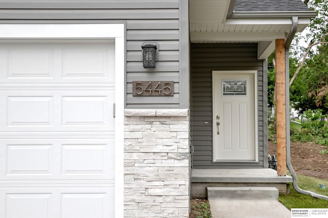 5445 S 51st St, Omaha, NE 68117 - entrance to property with stone siding and a shingled roof