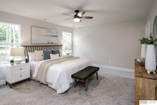 5445 S 51st St, Omaha, NE 68117 - bedroom featuring multiple windows, light carpet, baseboards, and a ceiling fan